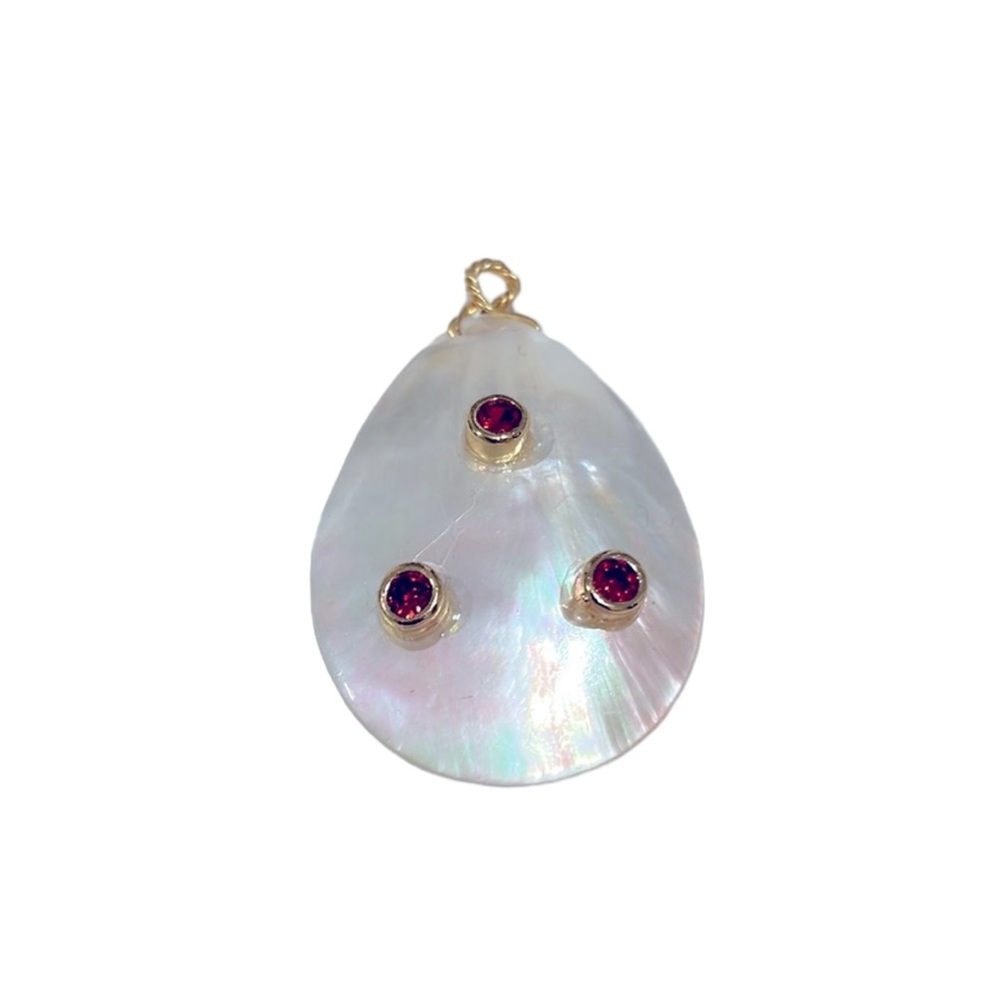 Teardrop shape shell pendant with three small garnets. New. Never worn.